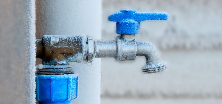 Image of a frozen pipe outside of home