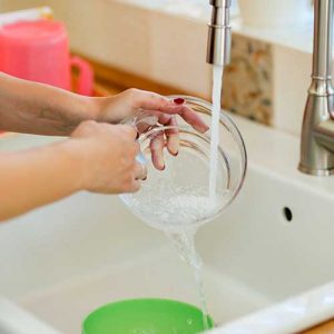 Image of hands washing dishes 