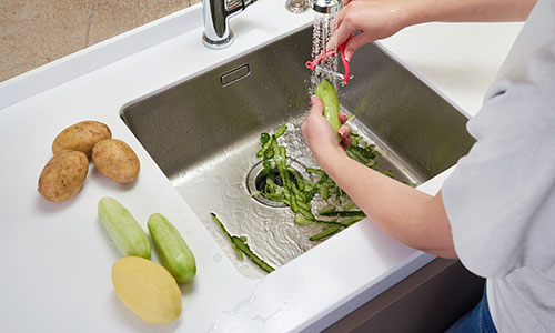 Person using the garbage disposal