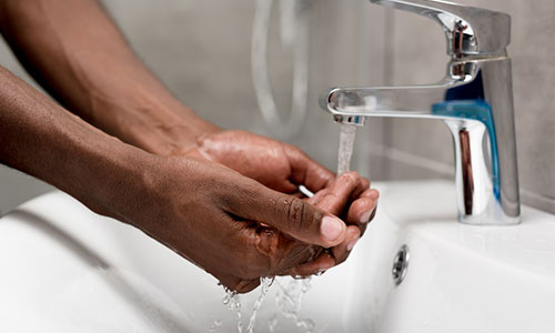 Person washing hands with low water pressure