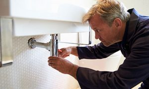 Plumber fixing low water pressure in plumbing
