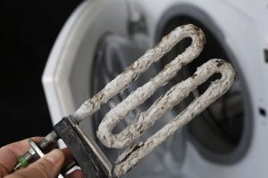 A corroded coil in a water heater needing replacement