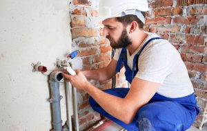 plumber inspecting an apartment plumbing problem