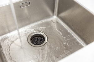Water runs into a garbage disposal that is not working.