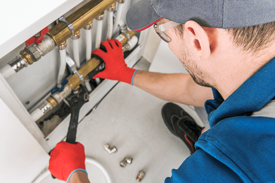 A plumber installing new plumbing to increase home value.