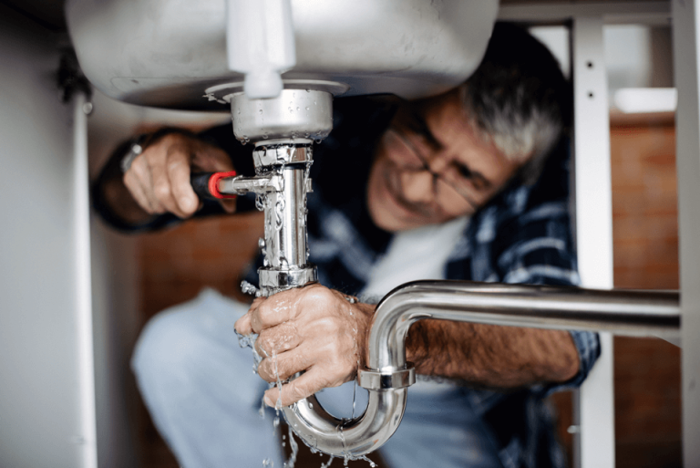 A master plumber fixing a sink.