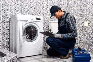 A plumber inspecting problems with a washing machine.