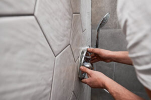plumber adjusting water pressure for shower